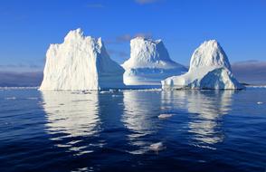 white icebergs against the blue sea in Greenland