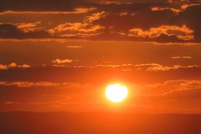 Beautiful and colorful sunset, among the clouds, in the evening, above the mountains