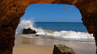 stone arch on the beach by the ocean