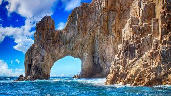rock arch on the turquoise ocean