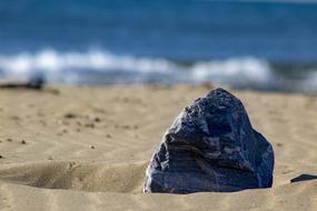gray stone on a sandy beach