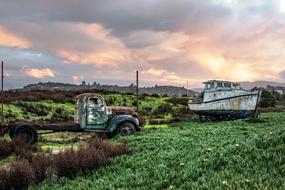 wrecked Fishing Boat Ship and vehicle on meadow