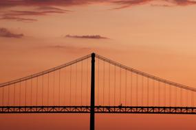 photo of the bridge against the background of the evening pink sky