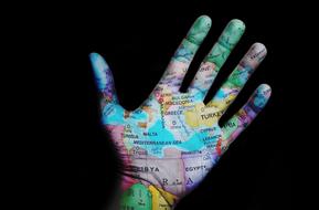 clipart of World Travel Map on hand