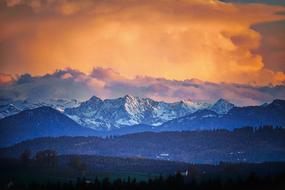 panoramic view of the snow-capped mountains at orange dusk