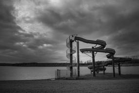 water slide on the beach in black and white