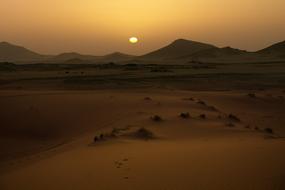 sunrise over the sands in the desert in morocco