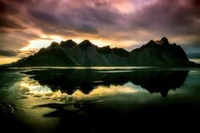 Beautiful mountains under beautiful and colorful sky with clouds in Iceland