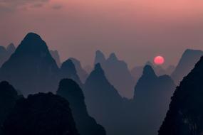 sun over the mountains as a fantastic landscape at dusk