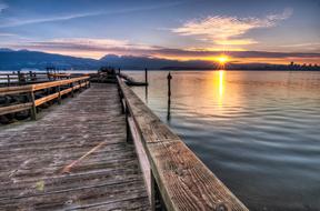 dramatic sunset over wooden pier