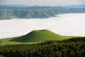 Landscape of the beautiful, green Komezuka near the white clouds in Kumamoto, Japan