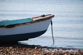 boat with a chain on the seashore