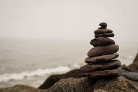 stone balance near the sea on a foggy day