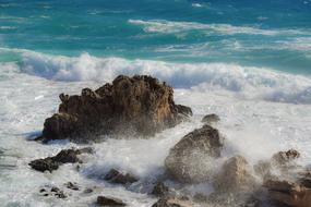 storm on a rocky shore on a sunny day