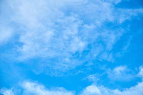 blue sky with white cloudy haze as background