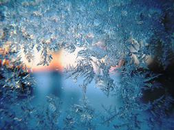 frosty winter morning through ice crystals