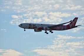 charter plane flies among white clouds