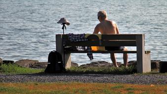 Sitting man on Bench near the sea