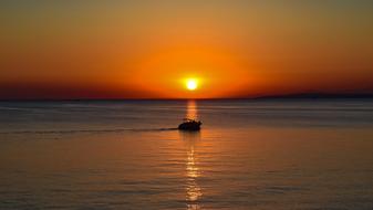 boat sails on the sea against the background of a colorful sunset in Ayia Napa, Cyprus