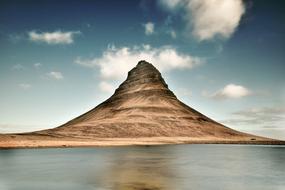 white clouds over a mountain in iceland