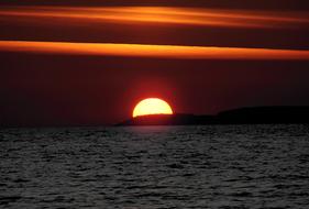 bright sun and golden stripes on the horizon at sunset