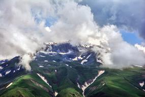 snow-capped peaks in white clouds