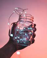 Hand with glass jar at Sunset Sky