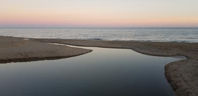 Beautiful river near the sea at beautiful and colorful sunset background