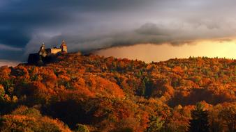 castle on hill over colorful autumn forest, Panorama