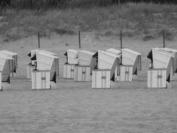 beach chairs on the sand in black and white background
