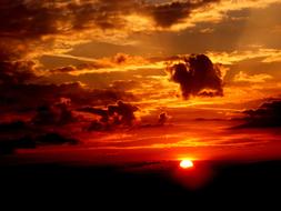 Beautiful red and orange sunset among the clouds on horizon