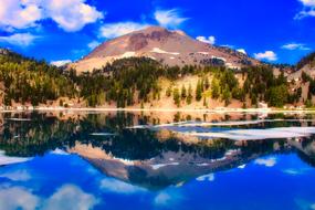 landscapes of the volcanic national park are reflected in the blue water