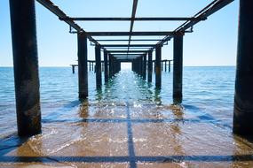 water under the old pier on a sunny day