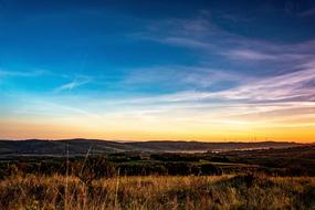 meadow against the background of colorful morning sky