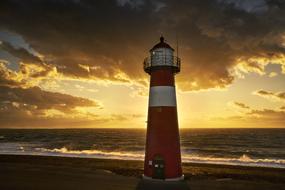 Lighthouse on north sea Beach at dusk