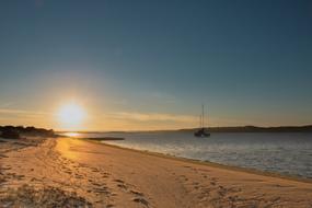 bright sun at sunset over a sandy beach