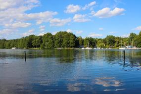 Beautiful village on the shore of the lake with green trees