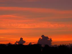 orange cumulus clouds in the evening sky