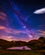 purple blue starry sky over mountain valley