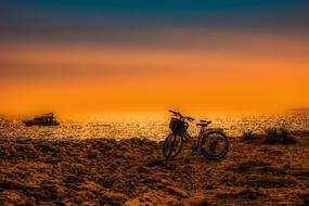 Bike on the beautiful beach, at colorful sunset in Ayia Napa, Cyprus, Greece