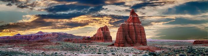 rocks in the desert under clouds at dusk