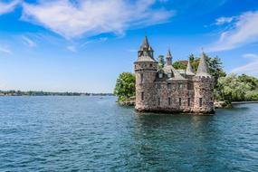 Beautiful landscape with the castle on the shore of the Thousand Islands, among the colorful plants