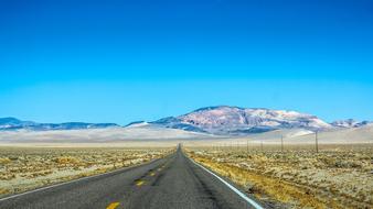 Beautiful highway, among the colorful fields and mountains, in Nevada, USA