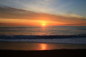 sunrise over a quiet surf