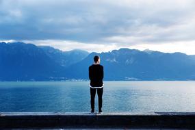lonely man on the coast in blue twilight