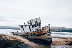 old rusty boat aground on the coast