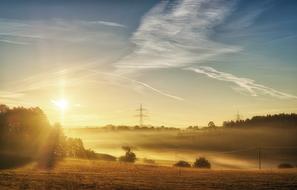 morning sun fog over rural landscape