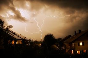 dramatic thunderstorm over residential buildings