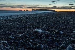 Beautiful landscape of the beach, with the shiny stones, at colorful and beautiful sunset, in Iceland