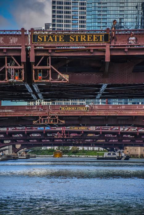 old multilevel steel bridge over water in city